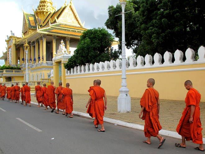 Monks and Cambodia Royal Palace Saffron-clad monks streaming past Phnom Penh's Royal Palace.