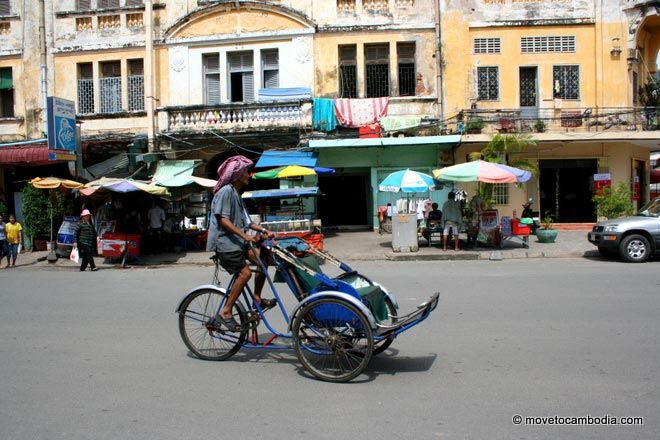 Cambodia cyclo A cyclo driver slowly wheels around Phnom Penh, Cambodia.