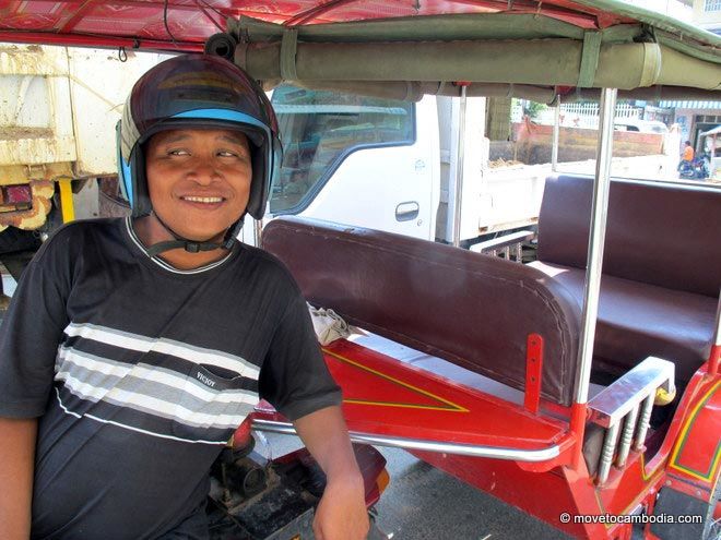 A tuk tuk driver in Cambodia giving a sidelong glance.