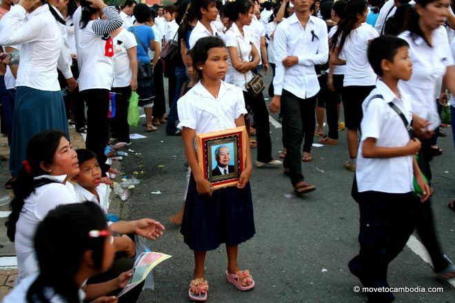 Girl holding photo of Norodom Sihanouk A young Cambodian girl holds a framed photograph of Norodom Sihanouk.