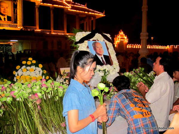 Norodom Sihanouk 4 Girl posing in front of memorial photo of king-father Norodom Sihanouk.