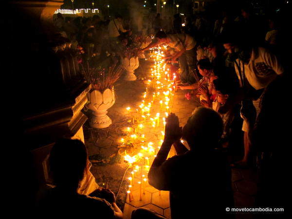 Norodom Sihanouk 5 A woman prays next to hundreds of lit candles for king-father Norodom Sihanouk.