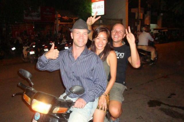 ramon Ramon Stoppelenburg driving a moto with two passengers in Cambodia